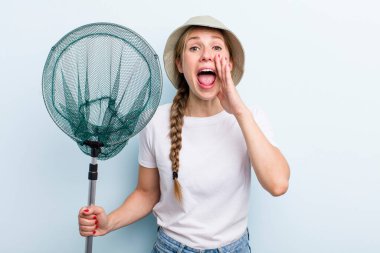 young adult blonde fisher woman with a net. holidays and hobbie concept