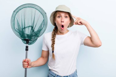 young adult blonde fisher woman with a net. holidays and hobbie concept