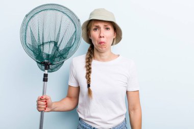 young adult blonde fisher woman with a net. holidays and hobbie concept
