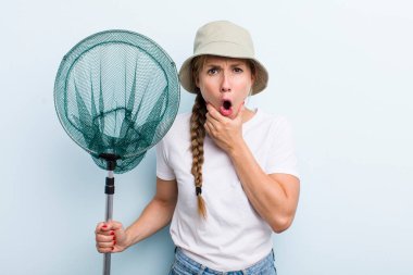 young adult blonde fisher woman with a net. holidays and hobbie concept