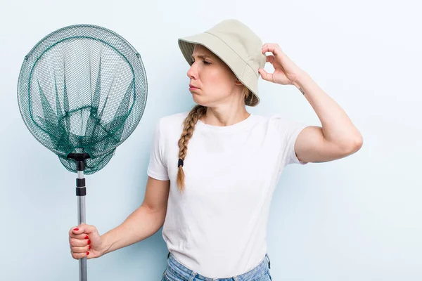 young adult blonde fisher woman with a net. holidays and hobbie concept