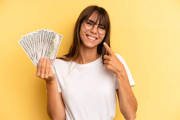 Hispanic Woman Smiling Confidently Pointing Own Broad Smile Dollar Banknotes — Foto de Stock
