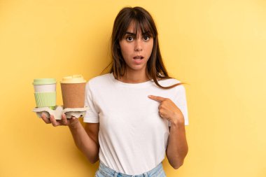 looking shocked and surprised with mouth wide open, pointing to self. take away coffees