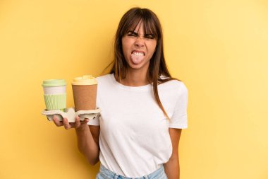 feeling disgusted and irritated and tongue out. take away coffees