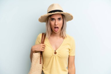 blonde woman looking very shocked or surprised. summer concept