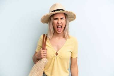 blonde woman shouting aggressively, looking very angry. summer concept