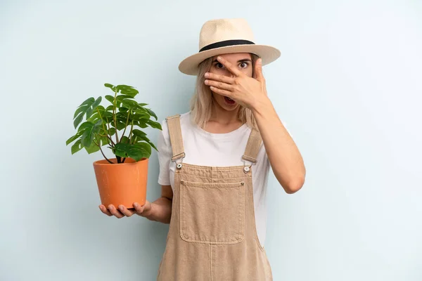 Blonde Woman Looking Shocked Scared Terrified Covering Face Hand Gardering — Fotografia de Stock