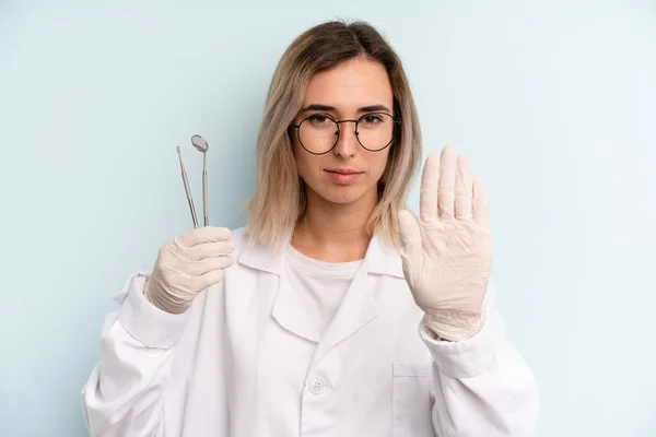 Blonde Woman Looking Serious Showing Open Palm Making Stop Gesture — Fotografia de Stock