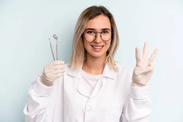 Blonde Woman Smiling Looking Friendly Showing Number Three Dentist Concept — Stockfoto