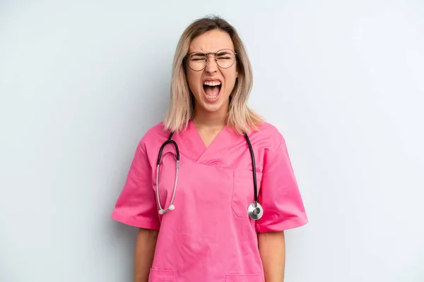 Blonde Woman Shouting Aggressively Looking Very Angry Nurse Concept — Stockfoto