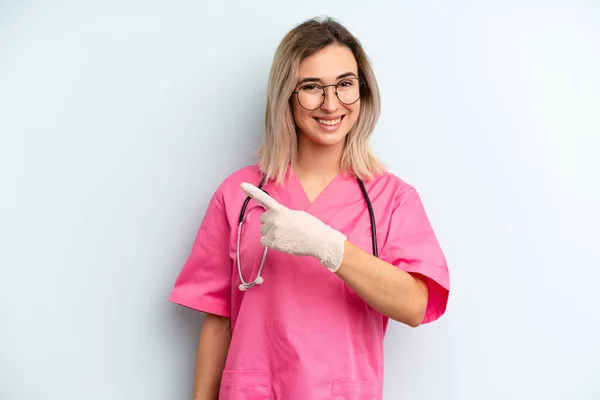 Blonde Woman Looking Excited Surprised Pointing Side Nurse Concept — Stockfoto