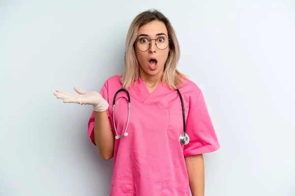 Blonde Woman Looking Surprised Shocked Jaw Dropped Holding Object Nurse — Stockfoto