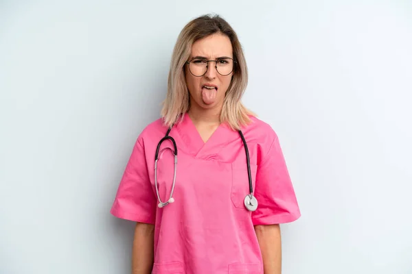 Blonde Woman Feeling Disgusted Irritated Tongue Out Nurse Concept — Foto Stock