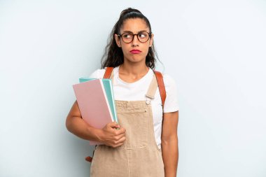 hispanic woman feeling sad, upset or angry and looking to the side. university student concept
