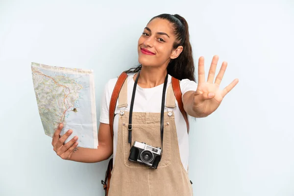 Hispanic Woman Smiling Looking Friendly Showing Number Four Tourist Map — 스톡 사진