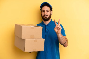 Genç adam gülümsüyor ve mutlu görünüyor, zafer ya da barış işareti yapıyor. Şirket çalışanı konsepti