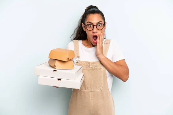 hispanic woman feeling shocked and scared. fast food take away concept