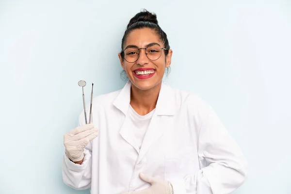 hispanic woman laughing out loud at some hilarious joke. dentist concept