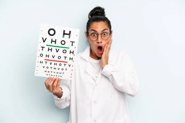 Hispanic Woman Feeling Shocked Scared Optical Vision Test Concept — Stockfoto