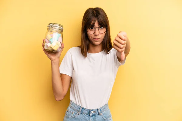 Hispanic Woman Feeling Cross Showing Thumbs Candies Bottle Concept — Fotografia de Stock