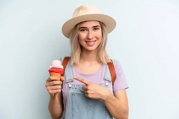 Blonde Woman Smiling Cheerfully Feeling Happy Pointing Side Ice Cream — Stockfoto