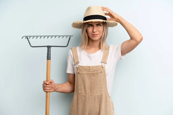 Blonde Woman Smiling Happily Daydreaming Doubting Farmer Rake Cocnept — Stockfoto