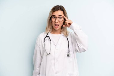 Sarışın kadın şaşkın ve şaşkın hissediyor, senin deli olduğunu gösteriyor. tıp öğrencisi konsepti