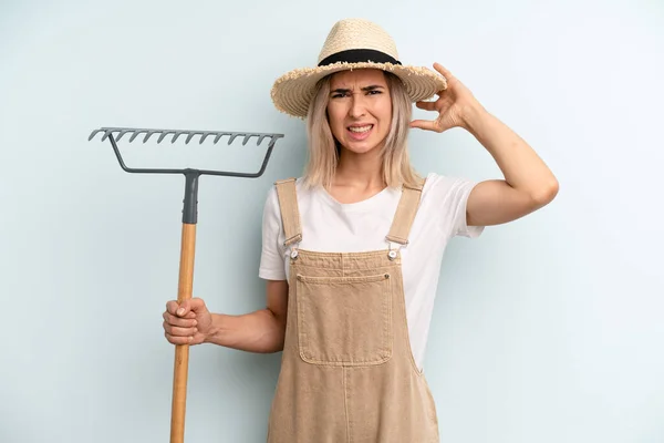 Blonde Woman Feeling Stressed Anxious Scared Hands Head Farmer Rake — Stockfoto