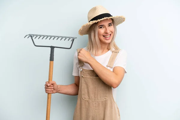 Blonde Woman Feeling Happy Facing Challenge Celebrating Farmer Rake Cocnept —  Fotos de Stock