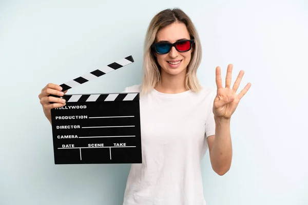 Blonde Woman Smiling Looking Friendly Showing Number Four Film Movie — Stockfoto