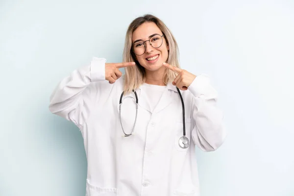 Blonde Woman Smiling Confidently Pointing Own Broad Smile Medicine Student — Stockfoto