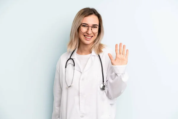 Blonde Woman Smiling Happily Waving Hand Welcoming Greeting You Medicine — Foto de Stock