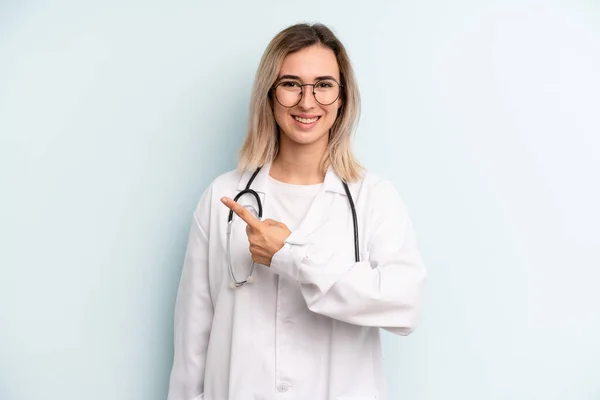 Blonde Woman Smiling Cheerfully Feeling Happy Pointing Side Medicine Student — Stockfoto