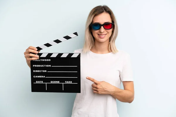 Blonde Woman Smiling Cheerfully Feeling Happy Pointing Side Film Movie — Stockfoto