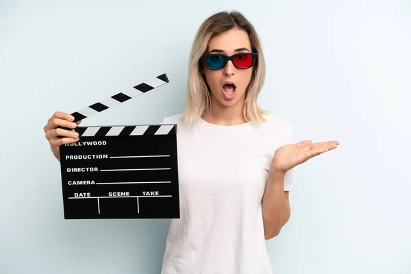Blonde Woman Looking Surprised Shocked Jaw Dropped Holding Object Film — Stockfoto