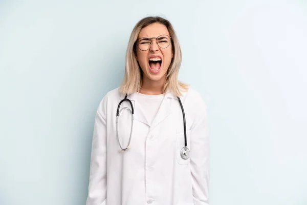 Blonde Woman Shouting Aggressively Looking Very Angry Medicine Student Concept — Zdjęcie stockowe