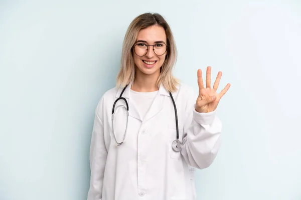 Blonde Woman Smiling Looking Friendly Showing Number Four Medicine Student — Foto de Stock