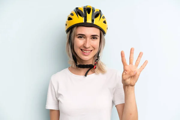Blonde Woman Smiling Looking Friendly Showing Number Four Bike Sport — Zdjęcie stockowe