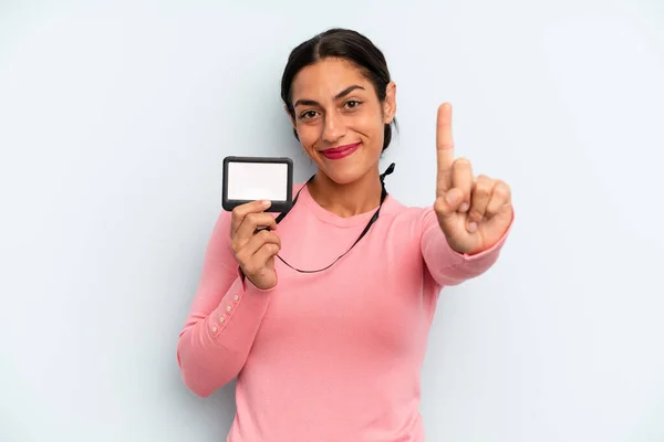 Hispanic Woman Smiling Looking Friendly Showing Number One Vip Pass — Stock Photo, Image