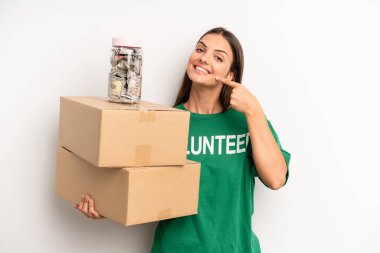 pretty woman smiling confidently pointing to own broad smile. volunteer and donation concept