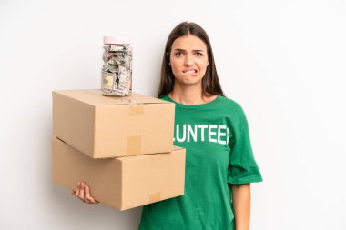 pretty woman looking puzzled and confused. volunteer and donation concept
