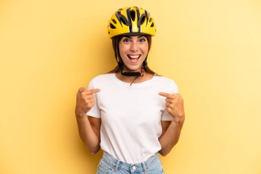 pretty woman feeling happy and pointing to self with an excited. bike sport concept
