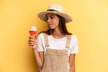 pretty woman on profile view thinking, imagining or daydreaming. ice cream and summer concept