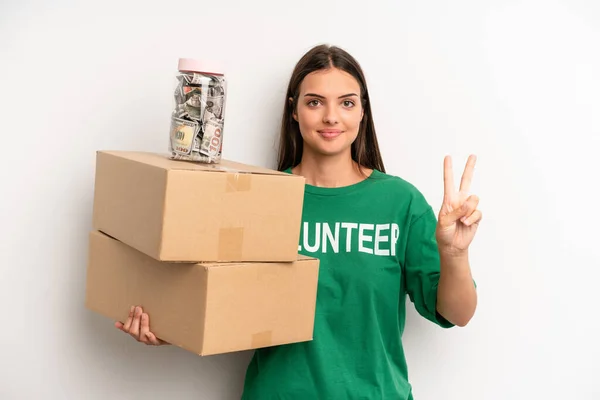 Pretty Woman Smiling Looking Happy Gesturing Victory Peace Volunteer Donation — Stockfoto