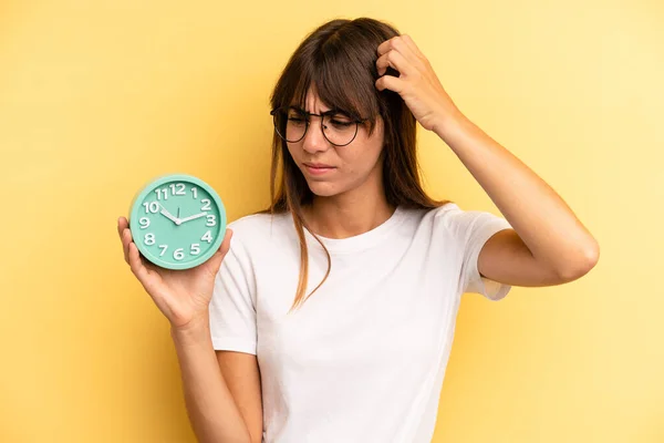 Hispanic Woman Feeling Puzzled Confused Scratching Head Alarm Clock Concept — Stockfoto