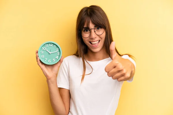 Hispanic Woman Feeling Proud Smiling Positively Thumbs Alarm Clock Concept — Foto de Stock