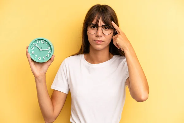 Hispanic Woman Feeling Confused Puzzled Showing You Insane Alarm Clock — Stock Fotó