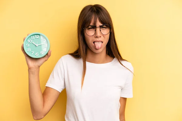 Hispanic Woman Feeling Disgusted Irritated Tongue Out Alarm Clock Concept — Stockfoto