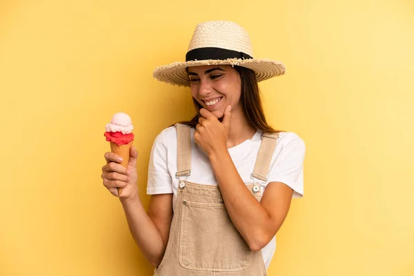 pretty woman smiling with a happy, confident expression with hand on chin. ice cream and summer concept
