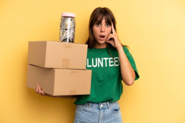 pretty woman looking surprised, realizing a new thought, idea or concept. volunteer and donation concept